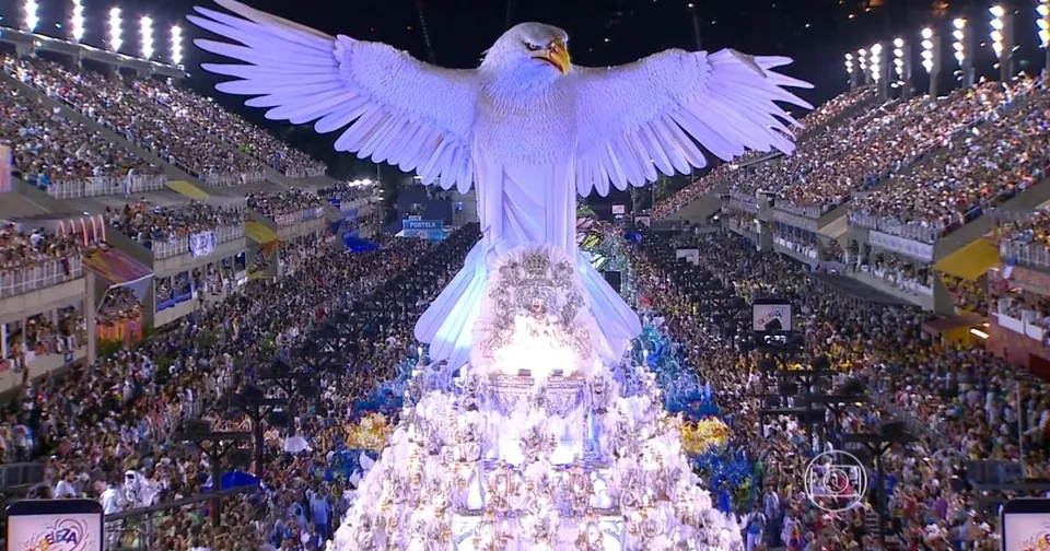A white float shaped like a giant bird in a samba school parade