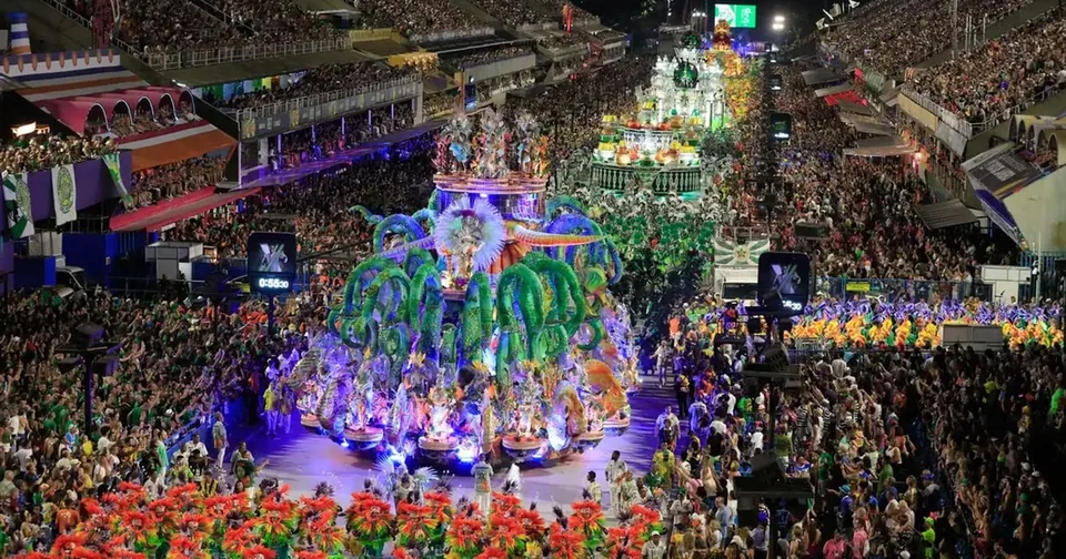 A wide view of the Sambódromo grandstands and a samba school on the avenue